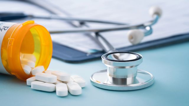 A prescription bottle and a medical document.