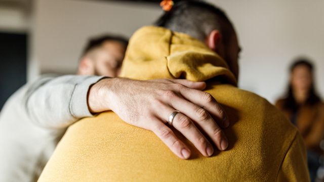 People at a support group for mental illness comfort one another.