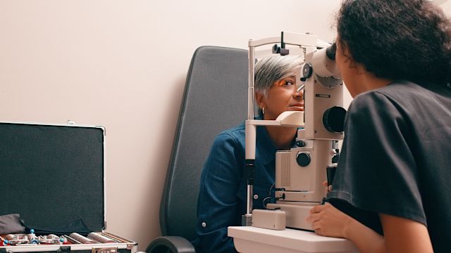 An eye doctor examines a woman's eye during an appointment. A good understanding of how diabetes can affect the eyes can be helpful when working with a healthcare provider. 