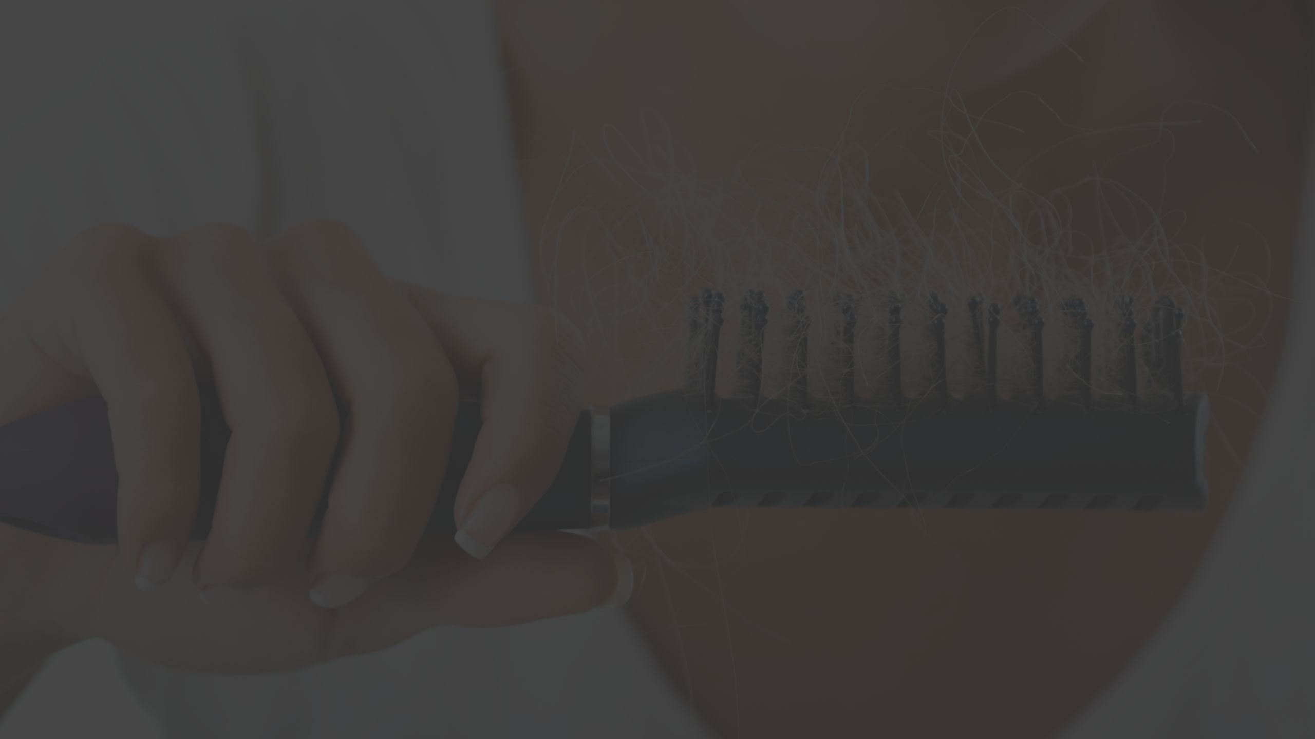 woman holding hair brush that is full of hair