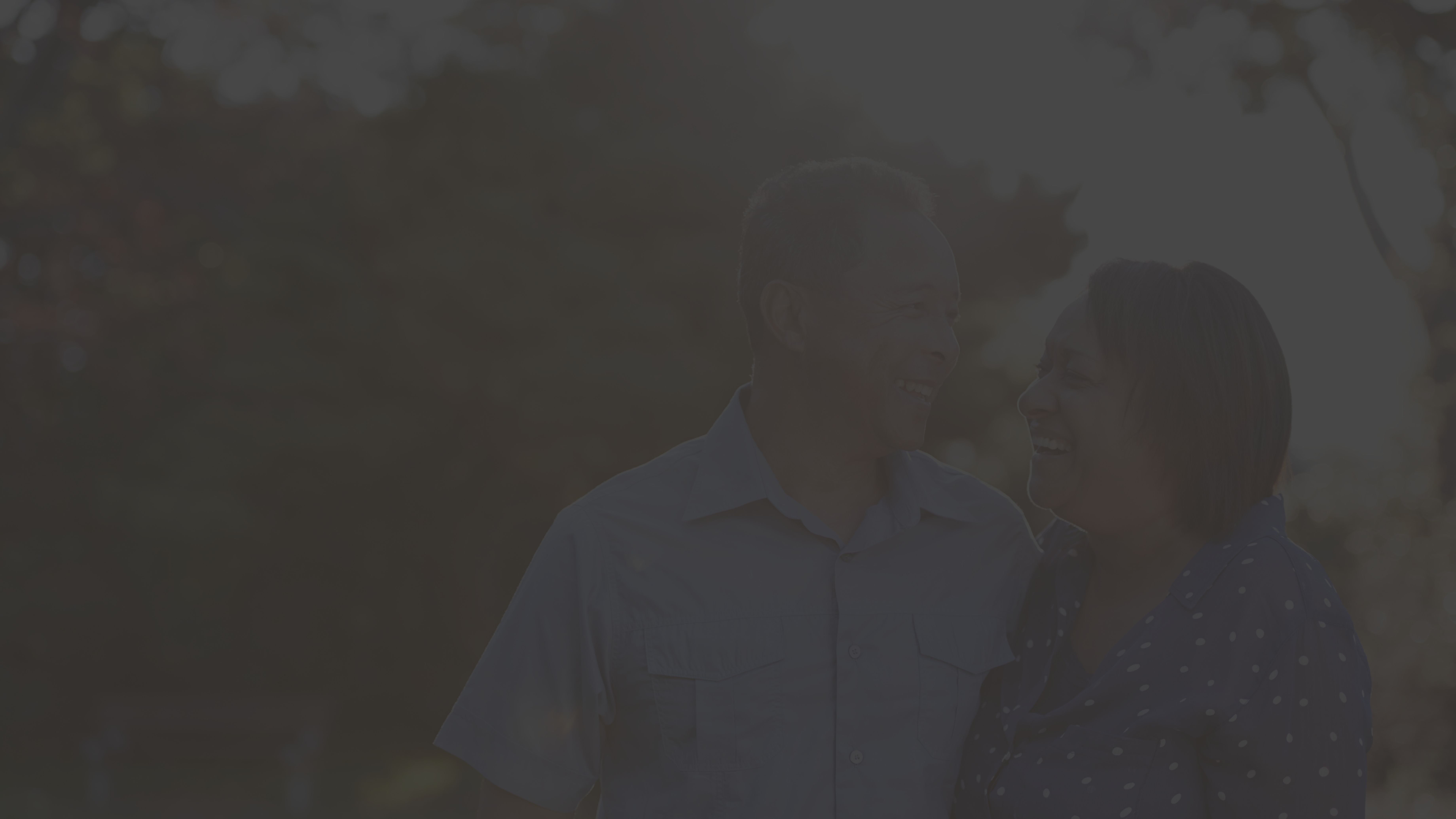 mature couple standing in yard