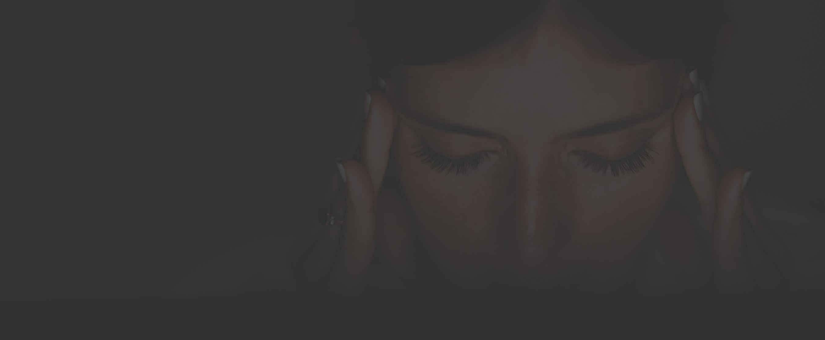 closeup of a woman's holding her temples