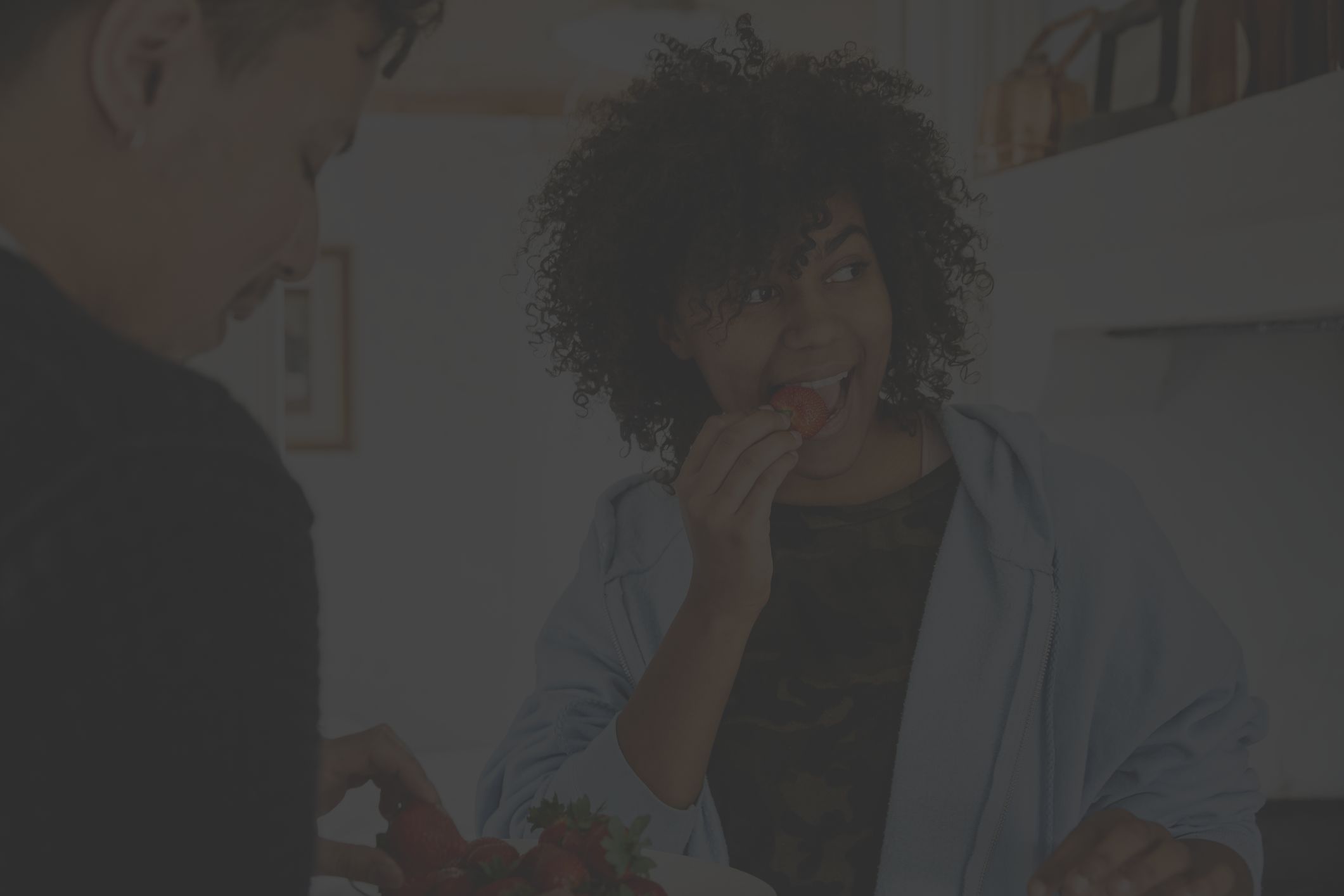 young woman eating strawberries