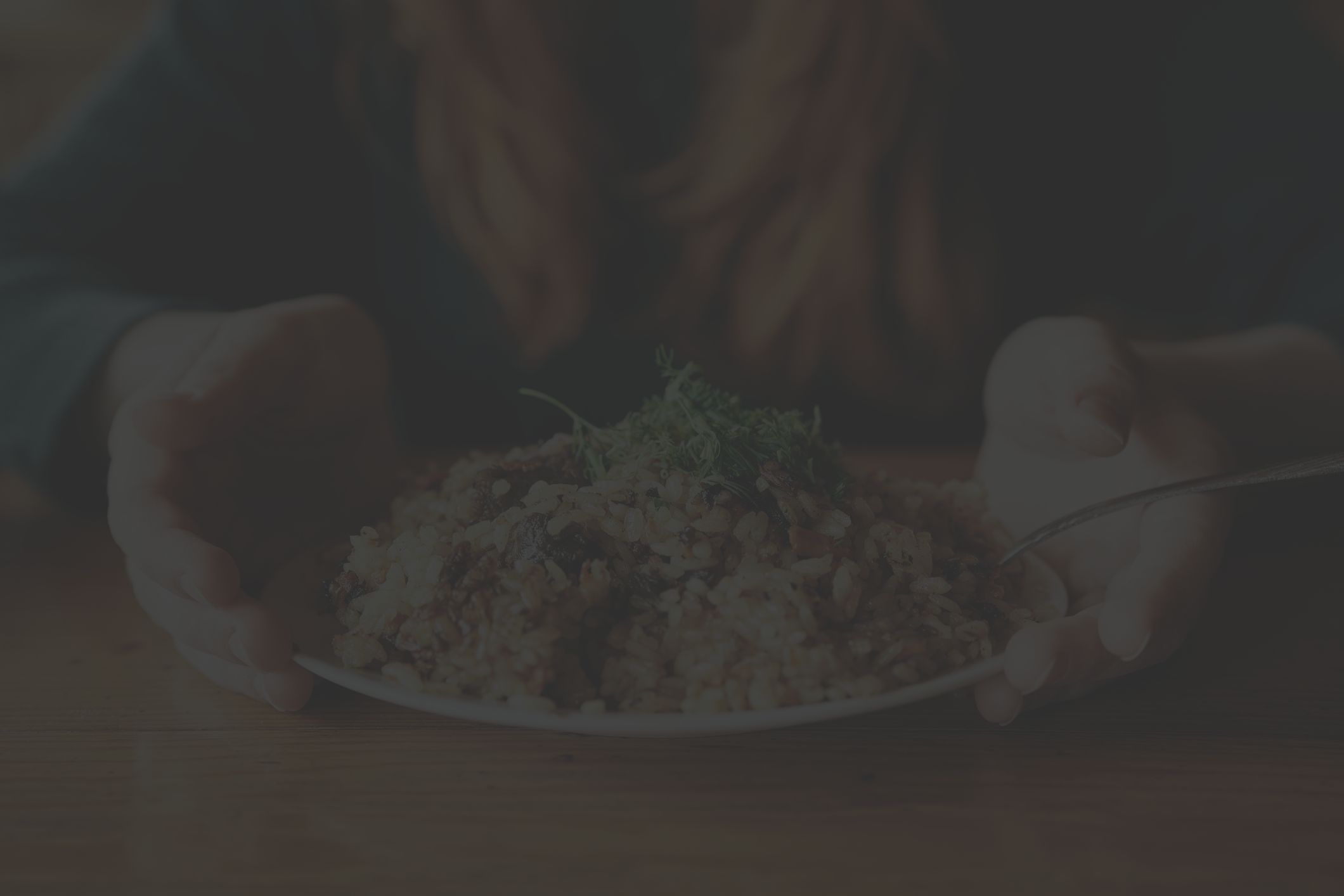 woman serving plate of rice