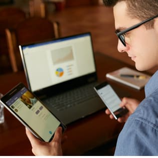 Man using multiple devices for work